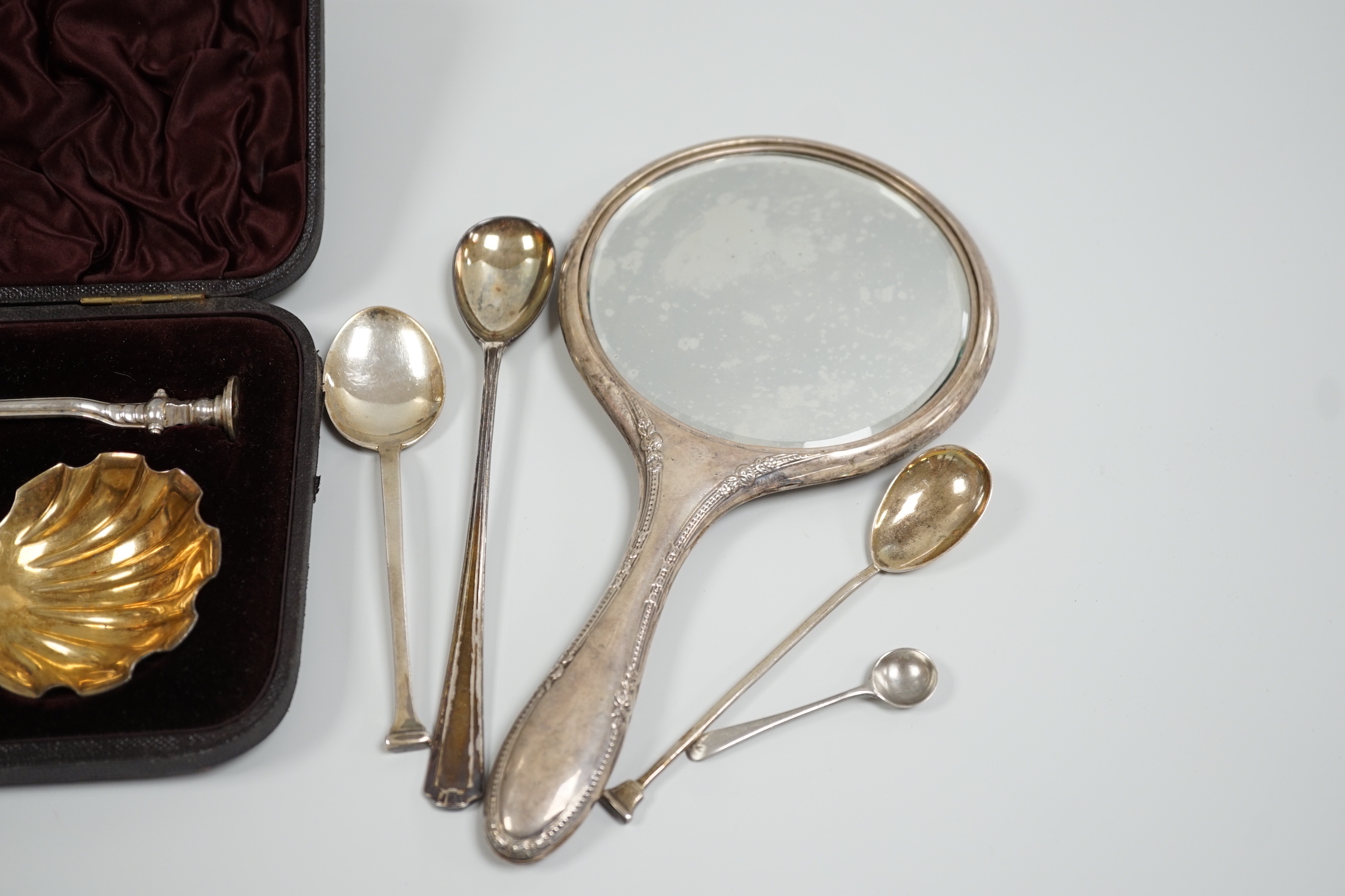 A cased pair of Victorian silver seal top serving spoons, Francis Higgins, London, 1887, 21.5cm, four other sundry silver spoons and a silver mounted hand mirror.